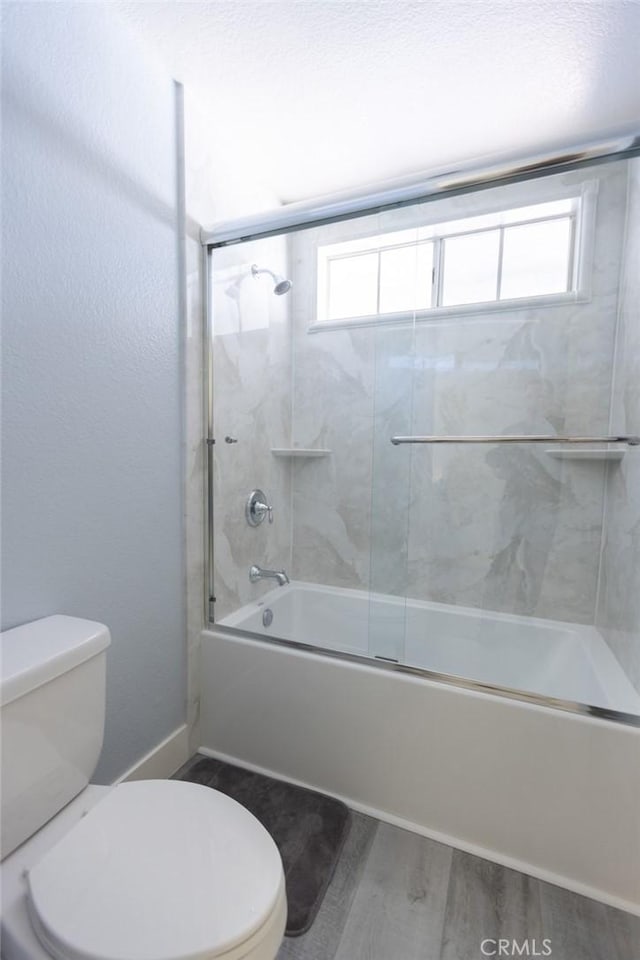 2196 Evergreen Dr, Tustin, CA 92782 - bathroom with toilet, wood finished floors, plenty of natural light, and combined bath / shower with glass door