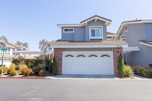 2196 Evergreen Dr, Tustin, CA 92782 - traditional-style house with brick siding, a garage, a pergola, and driveway