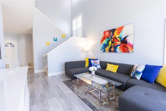 2196 Evergreen Dr, Tustin, CA 92782 - living area with stairway, wood finished floors, and baseboards