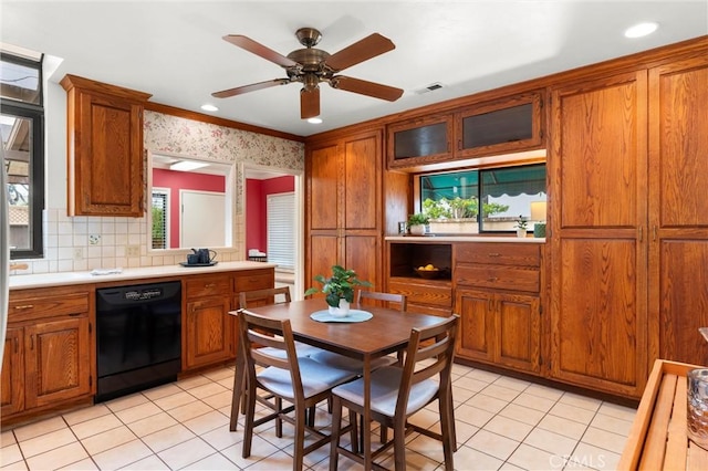 kitchen featuring black dishwasher, light tile patterned flooring, and brown cabinets