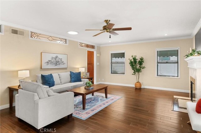 living room with visible vents, baseboards, ceiling fan, and a healthy amount of sunlight