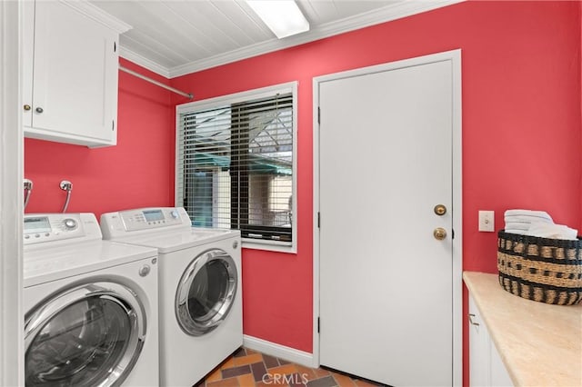 laundry area with cabinet space, crown molding, and washing machine and clothes dryer