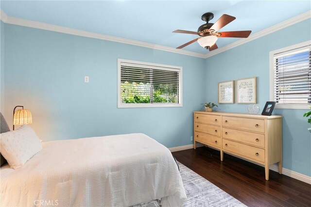 bedroom featuring a ceiling fan, baseboards, crown molding, and wood finished floors