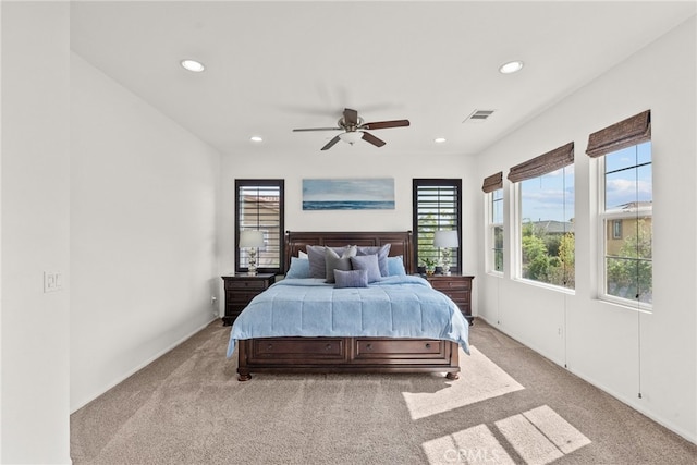 bedroom featuring visible vents, multiple windows, light colored carpet, and recessed lighting