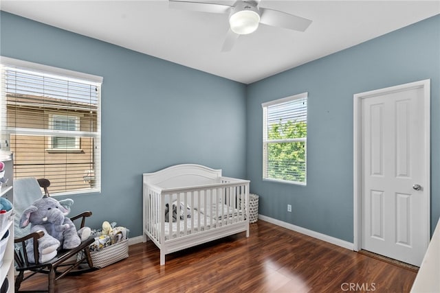 bedroom featuring baseboards, wood finished floors, and ceiling fan