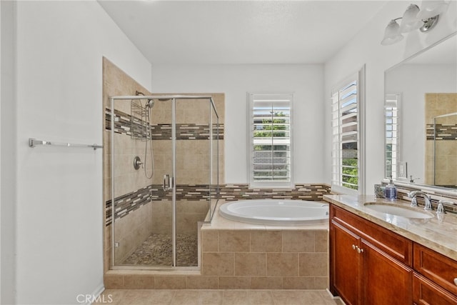 full bathroom featuring vanity, a shower stall, plenty of natural light, and a bath
