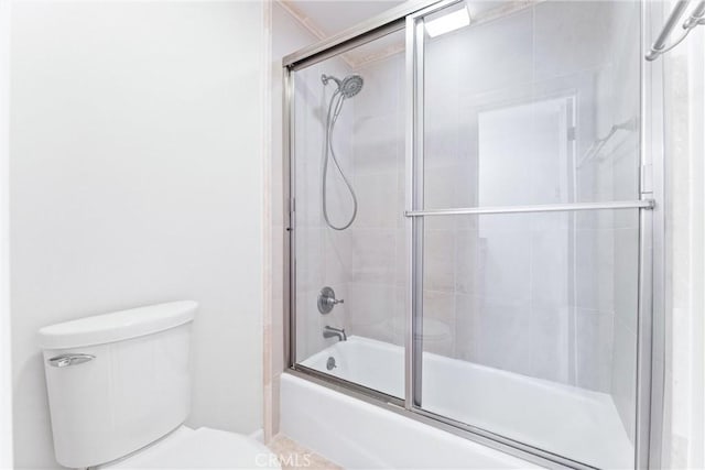 full bathroom with toilet and shower / bath combination with glass door