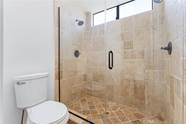 full bath with toilet and a stall shower