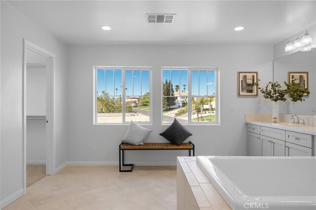 bathroom with recessed lighting, a bath, visible vents, and vanity