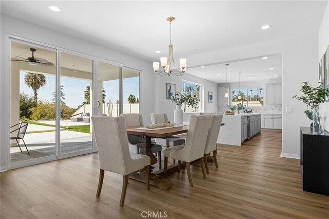 dining space with an inviting chandelier, wood finished floors, and recessed lighting