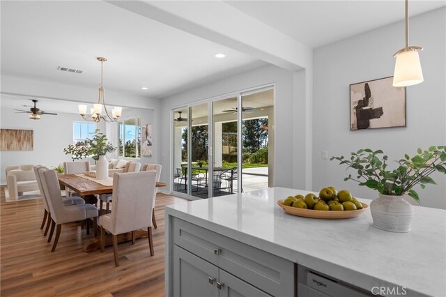 dining area featuring recessed lighting, wood finished floors, visible vents, and ceiling fan with notable chandelier