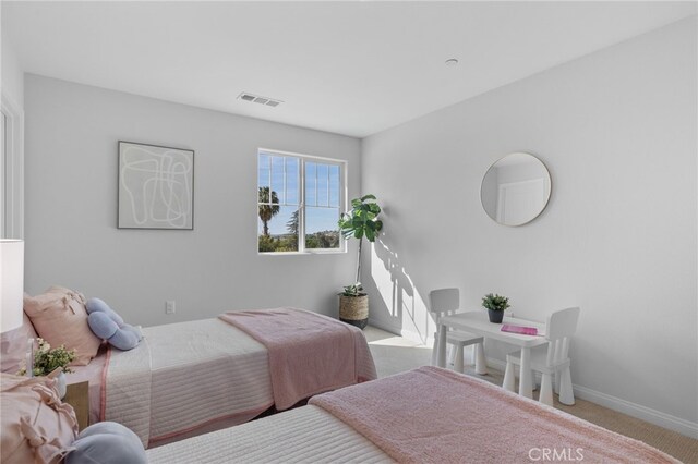 carpeted bedroom featuring visible vents and baseboards