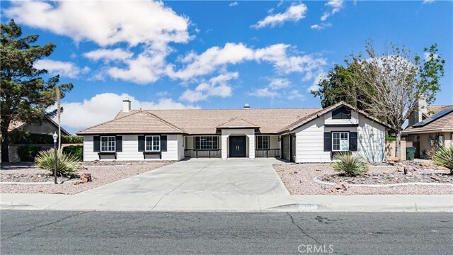 single story home featuring driveway and a chimney