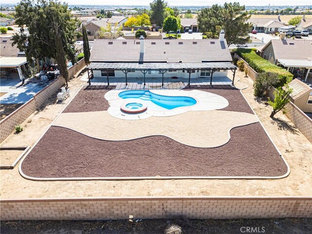 view of swimming pool featuring a fenced backyard, a patio area, a residential view, and a fenced in pool