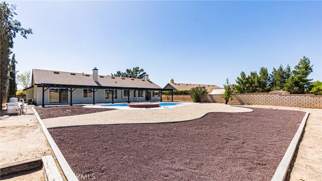 view of yard with a patio area, a fenced backyard, and a fenced in pool