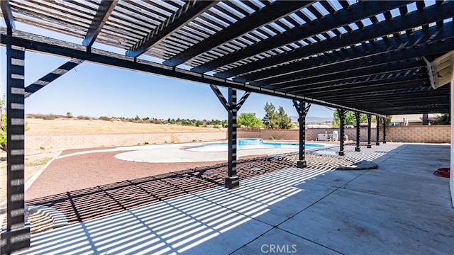 view of patio / terrace with fence, a pergola, and a fenced in pool