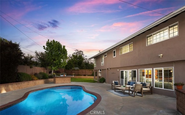 view of swimming pool with a patio, an outdoor living space, a fenced backyard, and a fenced in pool