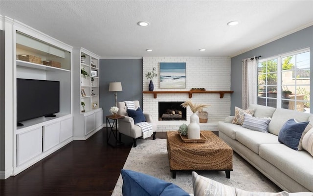 living area with built in shelves, dark wood finished floors, ornamental molding, and recessed lighting