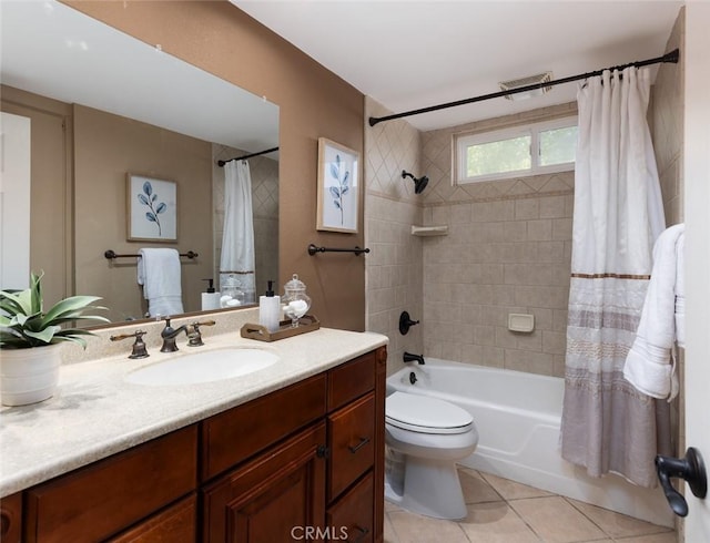 full bathroom featuring tile patterned floors, shower / bath combination with curtain, toilet, vanity, and visible vents