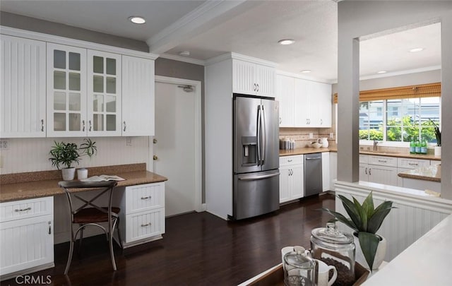 kitchen featuring decorative backsplash, glass insert cabinets, white cabinets, appliances with stainless steel finishes, and dark wood-type flooring