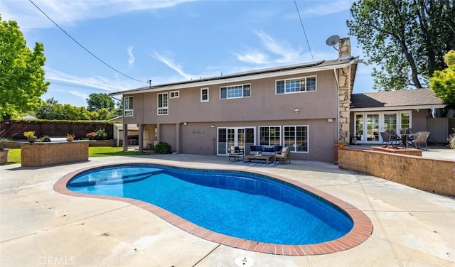 view of pool with a fenced in pool, french doors, a patio, and an outdoor living space