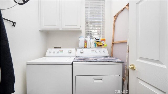 laundry room with cabinet space and washer and clothes dryer