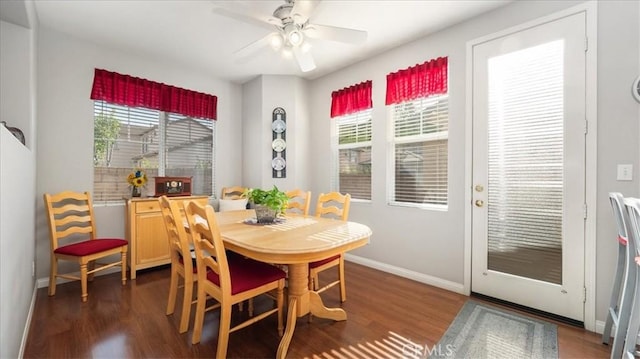 dining space with baseboards, ceiling fan, and dark wood finished floors
