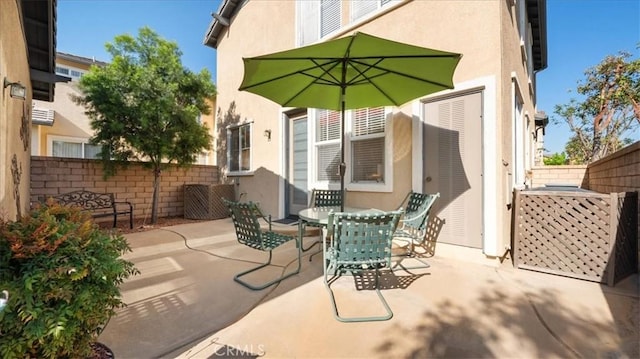 view of patio featuring fence and outdoor dining space