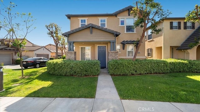 view of front of home with a front lawn and stucco siding