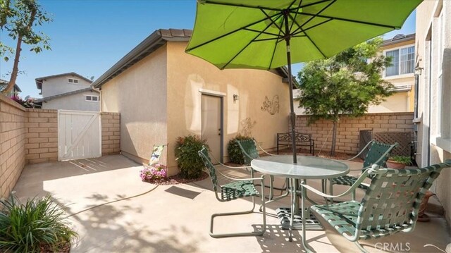 view of patio featuring fence and outdoor dining space