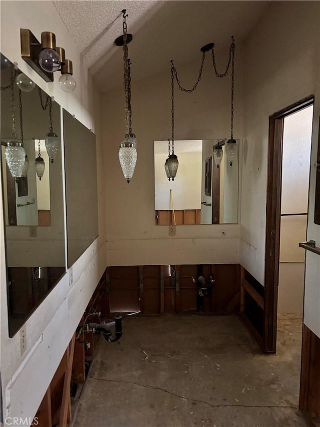 7890 Mariposa Trl, Yucca Valley, CA 92284 - bathroom featuring unfinished concrete flooring, lofted ceiling, and a textured ceiling