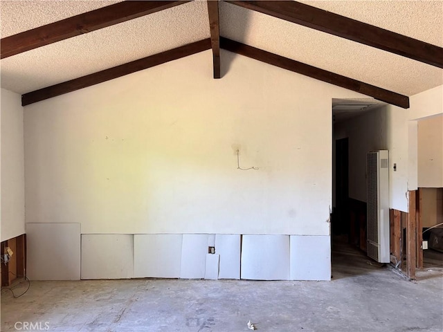 7890 Mariposa Trl, Yucca Valley, CA 92284 - empty room with a heating unit, beamed ceiling, and concrete flooring