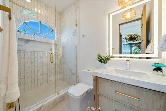 full bathroom with toilet, vanity, and a marble finish shower
