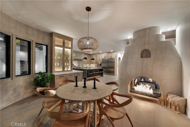 dining area with a notable chandelier, light wood-style floors, and recessed lighting