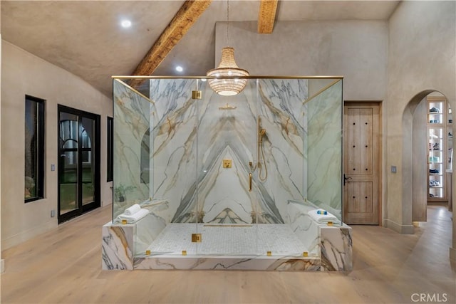 interior space featuring beamed ceiling, wood finished floors, a marble finish shower, and recessed lighting