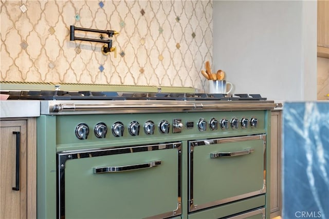 details with green cabinetry and range with two ovens