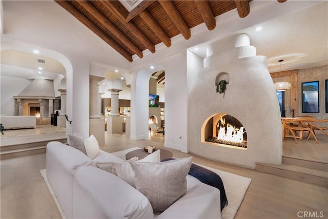 1090 Vista Ridge Ln, Westlake Village, CA 91362 - living room featuring a warm lit fireplace, wood ceiling, recessed lighting, and arched walkways