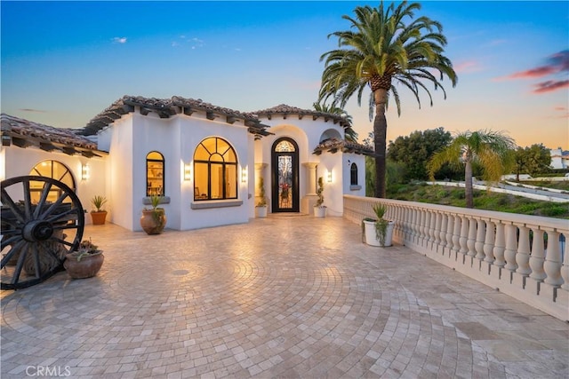 mediterranean / spanish-style house with stucco siding and a tile roof
