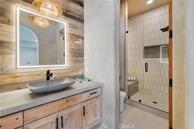 full bathroom featuring vanity, a shower stall, and toilet