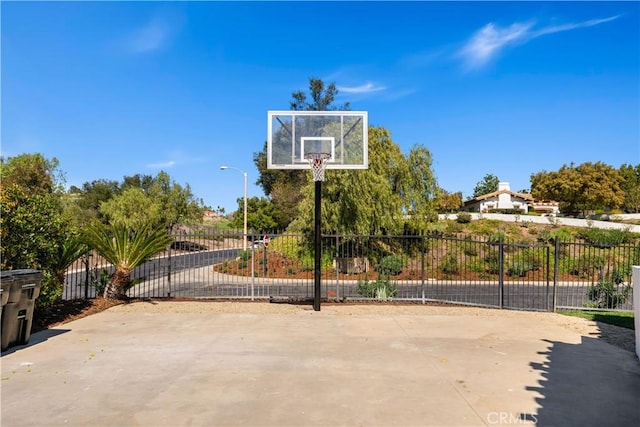 view of basketball court with community basketball court and fence