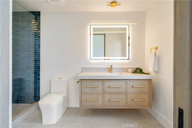 bathroom featuring vanity, toilet, tile patterned flooring, and tiled shower
