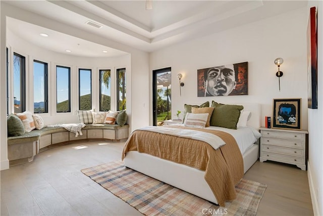 bedroom with recessed lighting, light wood-style floors, visible vents, and access to exterior