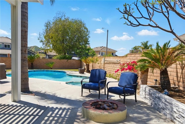 view of pool featuring a patio, an outdoor fire pit, and a fenced in pool