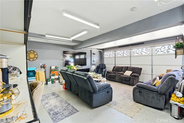 living area featuring speckled floor and a garage