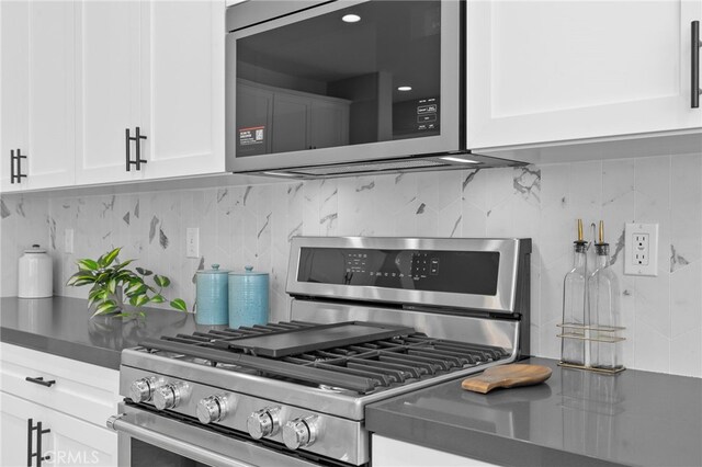 kitchen featuring decorative backsplash, white cabinetry, and stainless steel appliances