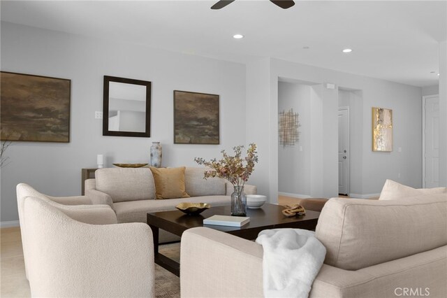 living area featuring ceiling fan, baseboards, and recessed lighting