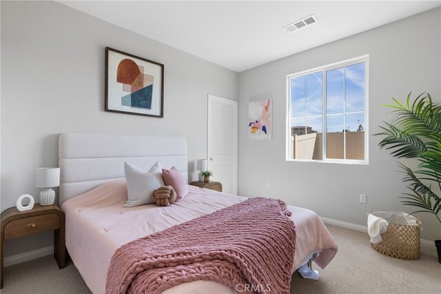 bedroom with baseboards, carpet flooring, and visible vents