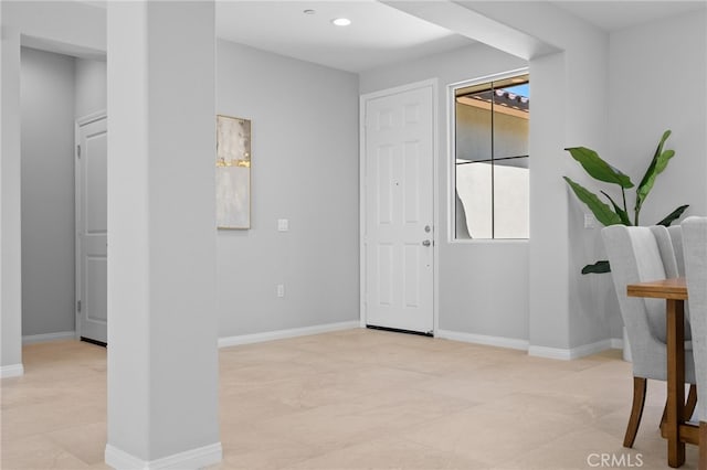 entryway with recessed lighting and baseboards