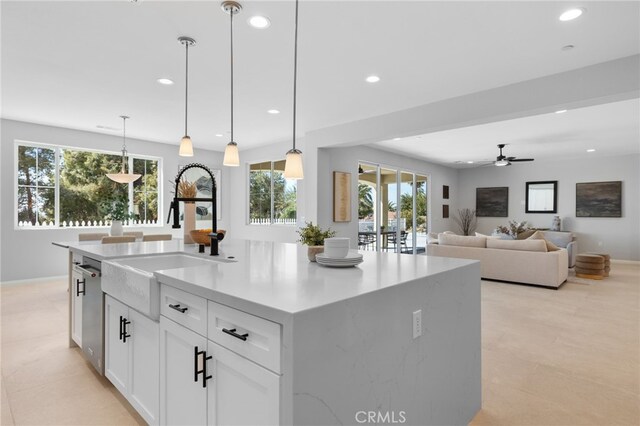 kitchen featuring recessed lighting, a wealth of natural light, stainless steel dishwasher, and a sink