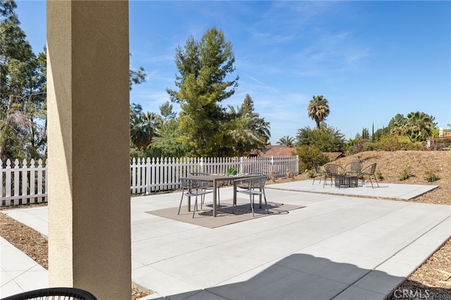 view of patio / terrace featuring outdoor dining area and fence